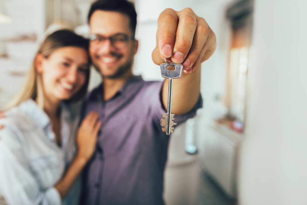 Happy smiling young couple showing